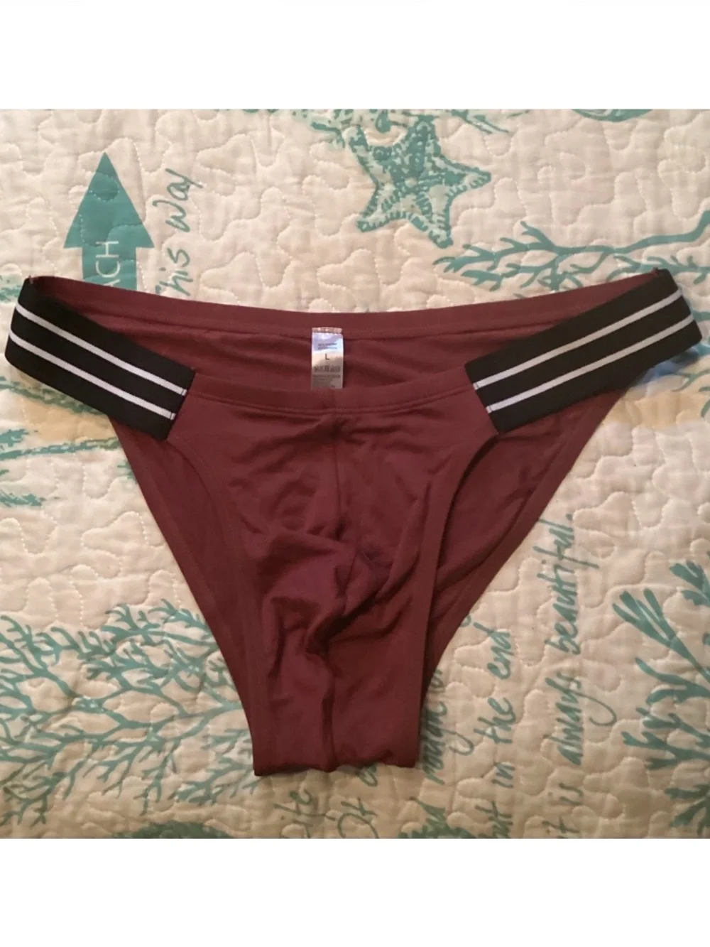 Sexy, burgendy color brief with black side straps.